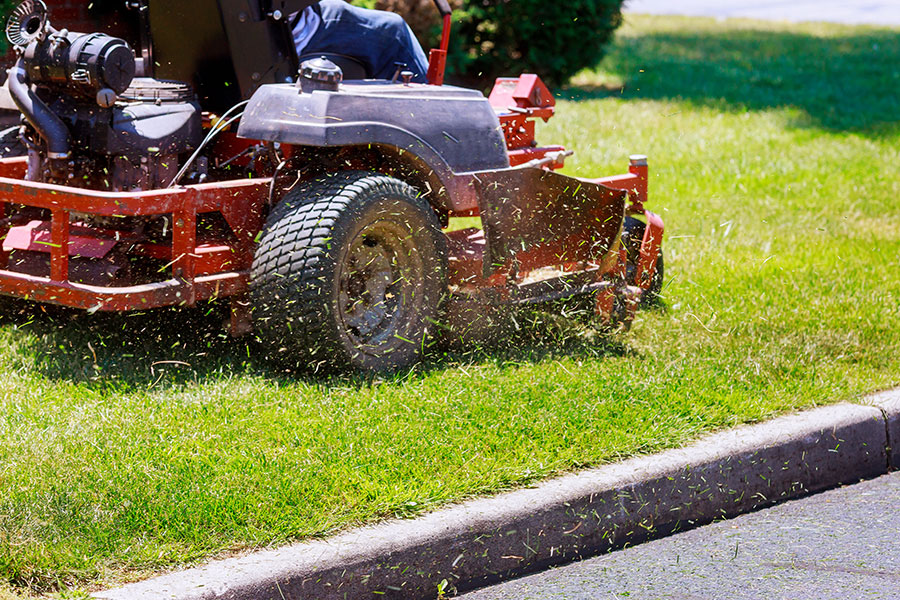A commercial lawn mower that is cutting the grass of a residential property for spring lawn maintenance in Springfield, IL.